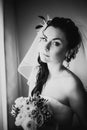 Black white photography beautiful young happy bride standing near the window Royalty Free Stock Photo