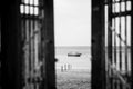 Black-white photography. Doors to alone boat in silent sea or ocean water Royalty Free Stock Photo