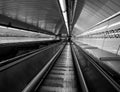 Black and white photography of the entrance of the subway station with mechanic stairways