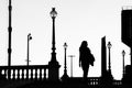 Black and white photography - lamps and a woman, Prague