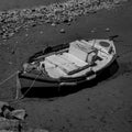 Black & White Photography of a Mediterranean Fishing Boat on the Beach caused by the Low Tide in Euboea - Nea Artaki, Greece Royalty Free Stock Photo