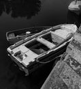 Black & White Photography of a Mediterranean Fishing Boat with a Small Boat on Water in Euboea - Nea Artaki, Greece Royalty Free Stock Photo
