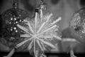 Black and white photography of transparent glass star shaped ornaments with line frosty pattern. Royalty Free Stock Photo