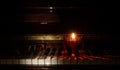 On black and white piano keys glasses are running. A candle is burning nearby. Royalty Free Stock Photo