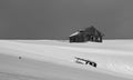 Black and white picture of an abandoned shepherd cottage in the mountains during winter with snow Royalty Free Stock Photo