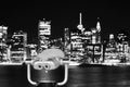 Binoculars pointed at Manhattan skyline at night, NYC. Royalty Free Stock Photo