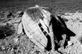 A black and white picture of a broken boat on the coast Royalty Free Stock Photo