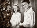 Black and white picture children under Christmas tree. Royalty Free Stock Photo