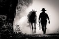 Black and white picture silhouette of cowboy and the horse in the morning sunrise