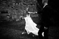 A black and white picture of a stunning bride walking along the Royalty Free Stock Photo