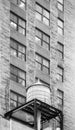 Black and white picture of water tower on a roof of an old building in Manhattan, New York City, USA Royalty Free Stock Photo