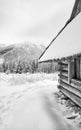 Black and white picture of wooden hut in mountains during snowy winter Royalty Free Stock Photo