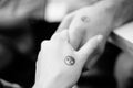 Black and white pictures. Two hands holding each other with yin and yang symbols. Royalty Free Stock Photo