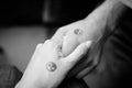 Black and white pictures. Two hands holding each other with yin and yang symbols. Royalty Free Stock Photo