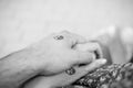 Black and white pictures. Two hands holding each other with yin and yang symbols. Royalty Free Stock Photo