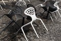 Black and white plastic chairs in a street cafe Royalty Free Stock Photo