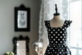 black and white polkadot summer dress on mannequin, in sleek decor