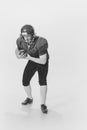 Black and white portrait of american football player in vintage style sports uniform isolated on white background Royalty Free Stock Photo