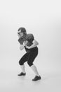 Black and white portrait of american football player in vintage style sports uniform isolated on white background Royalty Free Stock Photo