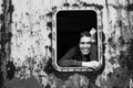 Young woman looking out of the window metal caboose.