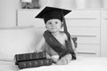 Black and white portrait of baby boy in graduation sitting with