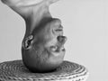 Black and white portrait of a bald man standing on his head Royalty Free Stock Photo