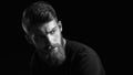 Black and white portrait of bearded handsome man in a pensive mood Royalty Free Stock Photo