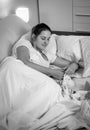 Black and white portrait of beautiful woman lying in bed at nigh Royalty Free Stock Photo