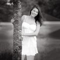 Black and white portrait of a beautiful young woman hugging a tree Royalty Free Stock Photo