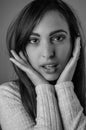 Black and white portrait of a beautiful young woman with long brown hair with her hands on her cheeks pretending amazement Royalty Free Stock Photo