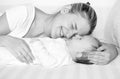 Black and white portrait of cheerful mother hugging and kissing Royalty Free Stock Photo