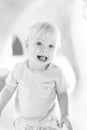 Black and white portrait of cute little infant baby boy child playing on outdoor playground. Toddler plays on school or Royalty Free Stock Photo