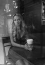 Black and white portrait of elegant blonde woman drinking coffee Royalty Free Stock Photo