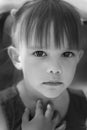 Portrait of an emotional 3-year-old girl with black expressive eyes