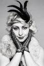 Black and white portrait of a girl in a hat with feathers and lace gloves Royalty Free Stock Photo