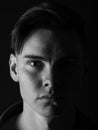 Black and white portrait of a handsome guy. Tired, sad young man on a black background. Stress concept. Royalty Free Stock Photo