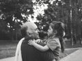 Black and white portrait of Happy grandfather and grandaughter playing at the park Royalty Free Stock Photo