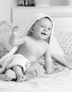 Black and white portrait of laughing toddler boy with towel on head after having bath Royalty Free Stock Photo