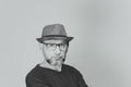 Black and white portrait of mature serious man. Wearing eyeglasses and a hat Royalty Free Stock Photo