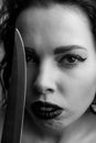 Black and white portrait of menacing gothic woman with a knife blade Royalty Free Stock Photo