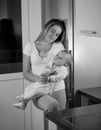 Black and white portrait of mother giving milk to her baby at ni Royalty Free Stock Photo