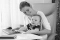 Black and white portrait of mother taking care of her baby and w