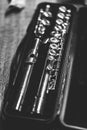 Black and white portrait of a music case with a disassembled metal silver flute in it with valves to play notes. the musical Royalty Free Stock Photo