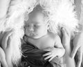 A black and white portrait newborn little boy sleeping surrounded by family, Hands of mom and dad hug a newborn baby,loving parent Royalty Free Stock Photo