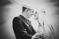 Black and white portrait of newly married couple.wind lifting up long veil Royalty Free Stock Photo