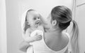 Black and white portrait of smiling baby boy covered in towel looking on mother after having bath Royalty Free Stock Photo