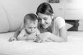 Black and white portrait of smiling mother and baby using tablet Royalty Free Stock Photo