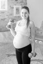 Black and white portrait of smiling pregnant woman posing with d Royalty Free Stock Photo