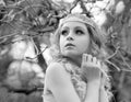 Black-white portrait of stunning young beauty blonde with jewelry for hair in the garden where magnolia trees bloom.  Jewelry for Royalty Free Stock Photo