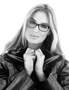 Black and white portrait of stylish young woman in glasses. Hair down